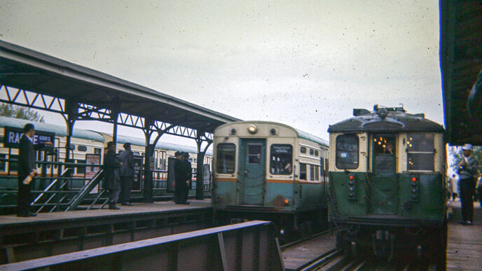 Vintage photo of an elevated train station platform with two trains on the tracks