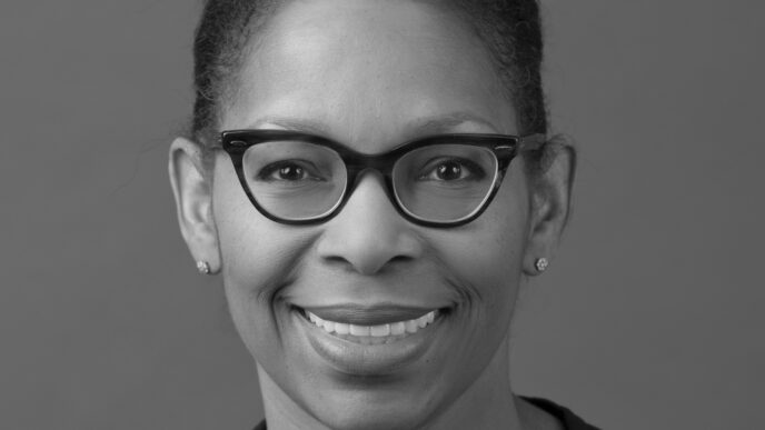 Headshot of Mary Richardson-Lowry smiling with glasses
